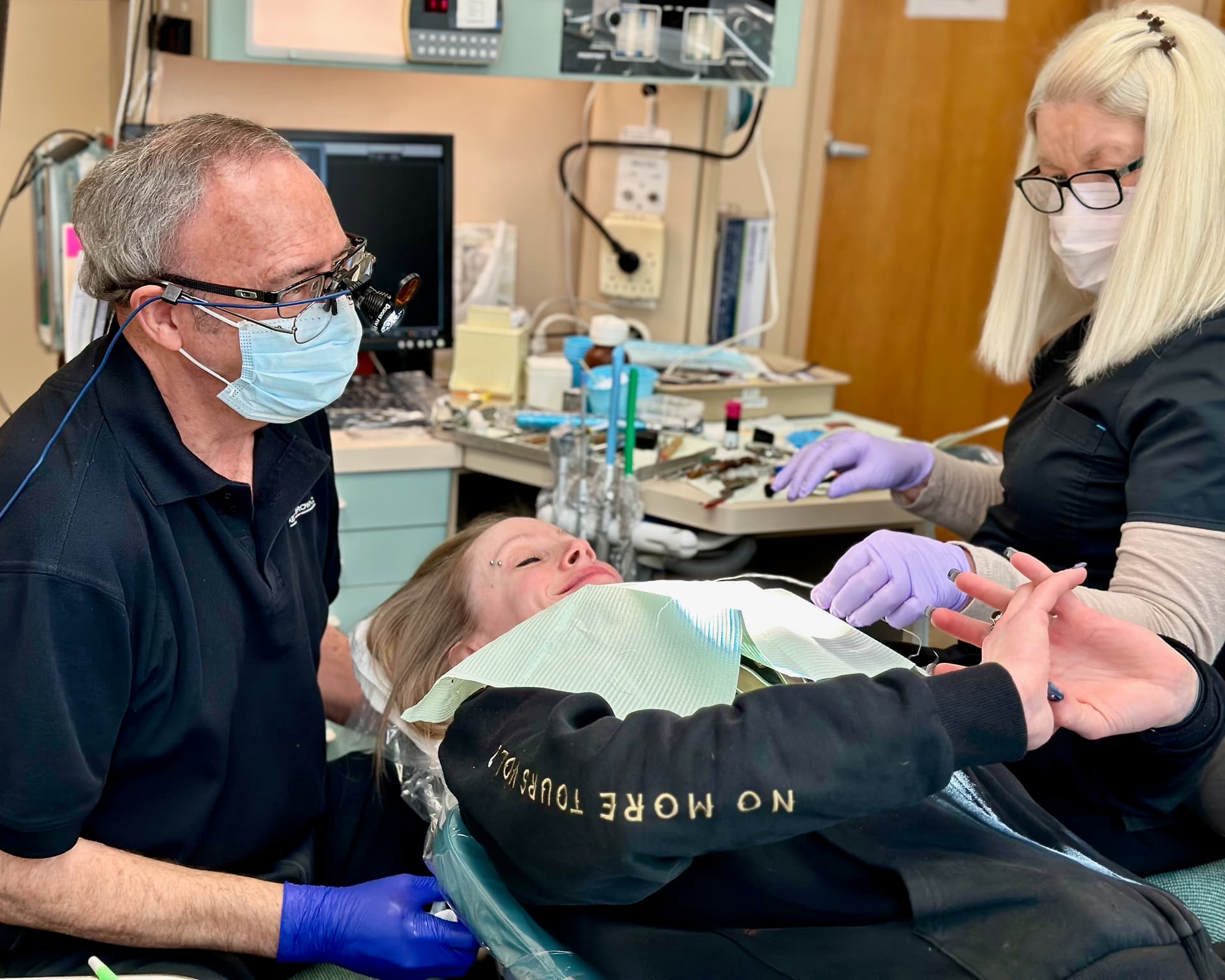 Dr. Keith A. Brown DDS, FAGD, talks with a satisfied patient after a dental visit.